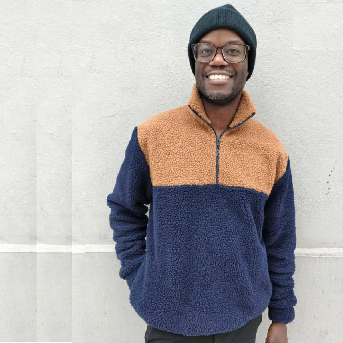 Man wearing a cozy Zip Up Sweater paper pattern in brown and navy color, ideal for layering in cooler weather.