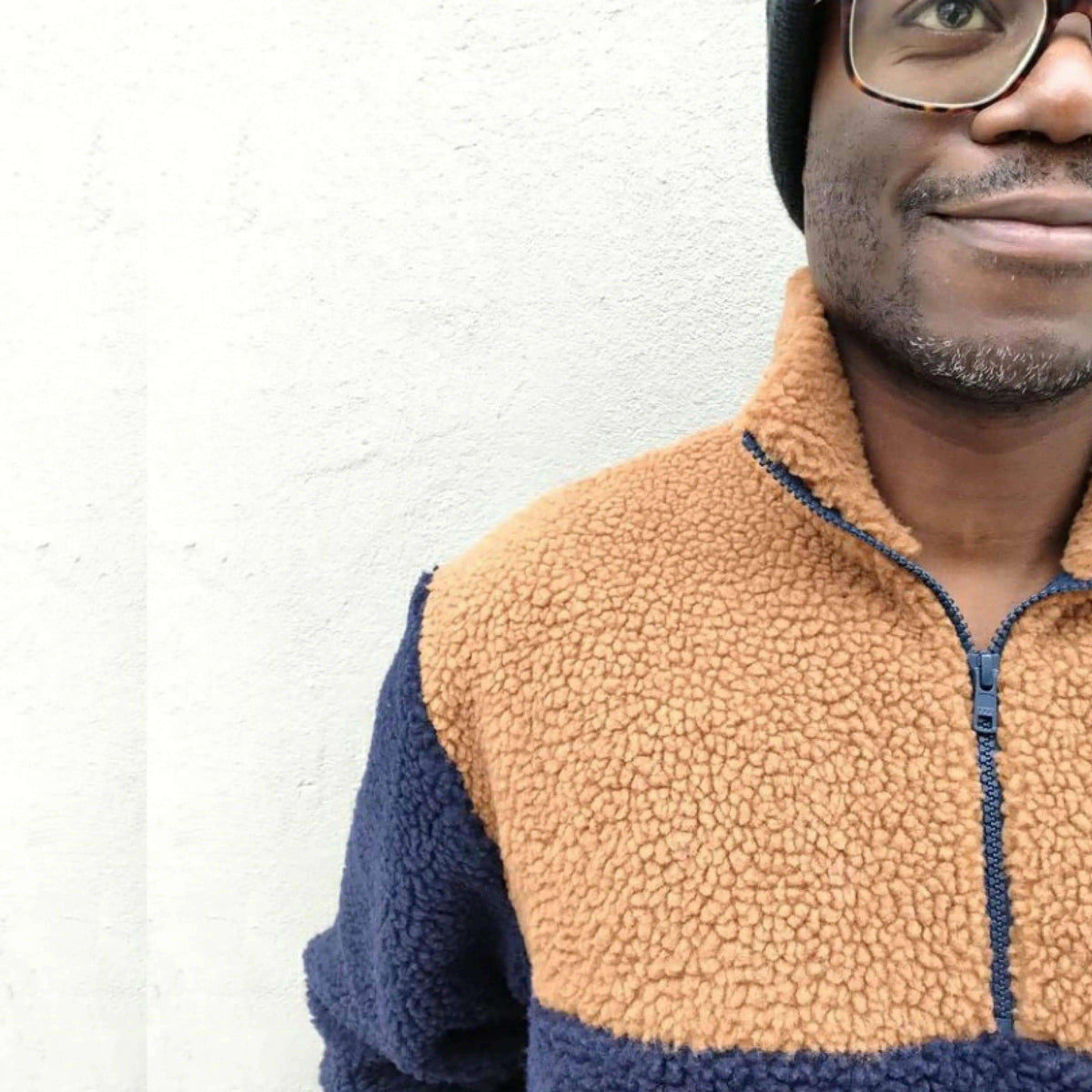Person wearing a cozy, zip-up sweater made from the Zip Up Sweater paper pattern, featuring a high collar and ribbed cuffs.