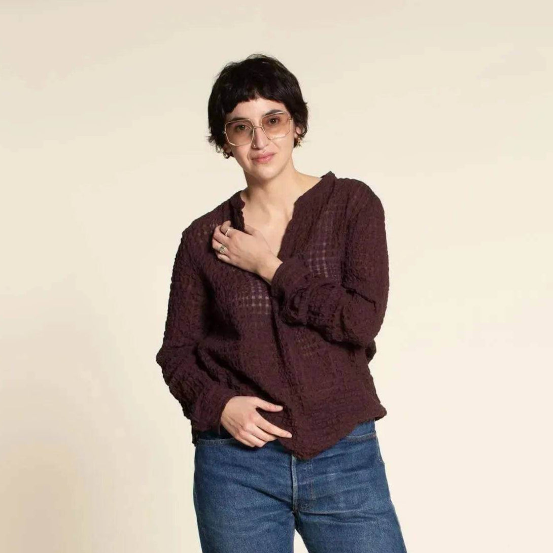 Woman wearing a relaxed dark purple top with glasses, showcasing the Perfect Tunic Paper Pattern style.