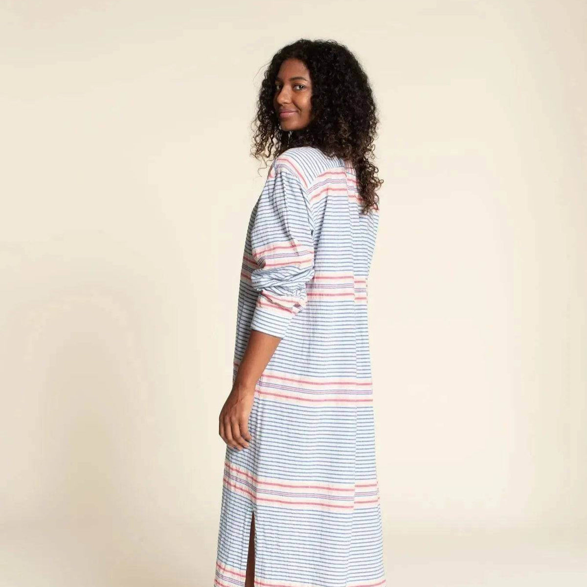 Woman wearing a Big Shirt Paper Pattern dress with stripes, showcasing the relaxed fit and stylish design.