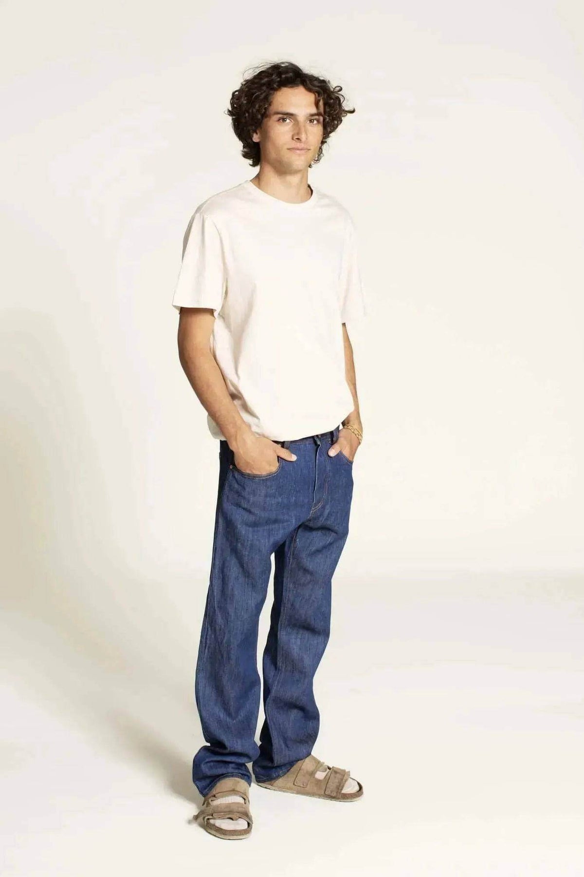 Model wearing Men's Jeans Paper Pattern with a casual t-shirt and sandals, showcasing relaxed fit and design.