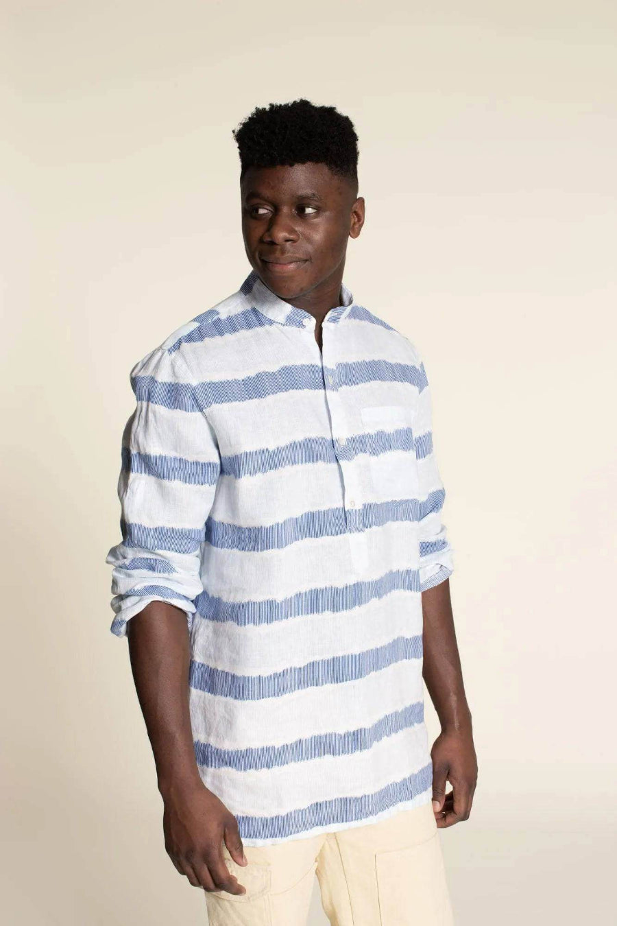 Men's Tunic paper pattern displayed on a model in a blue striped fabric with a banded collar.