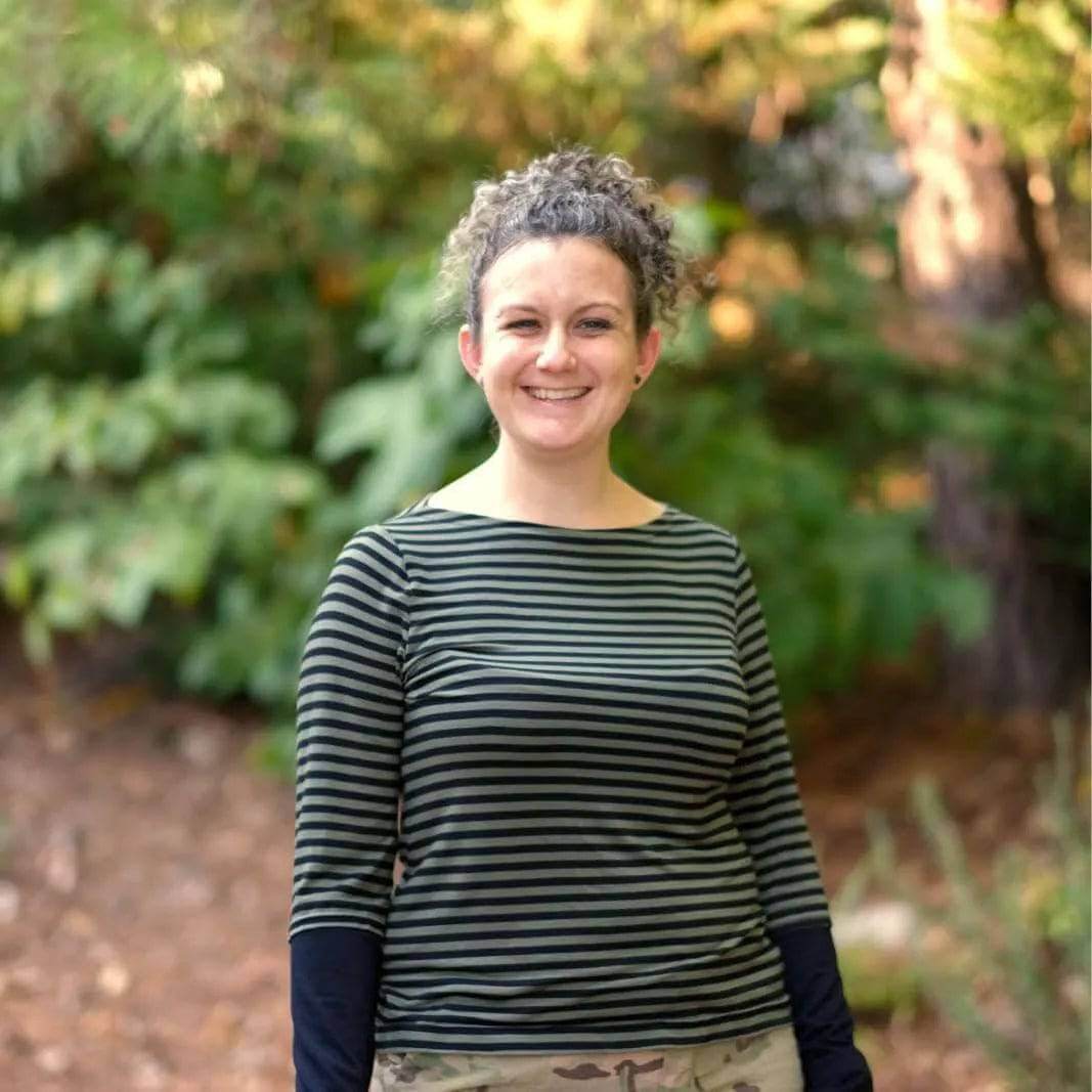 Woman in a striped T-shirt standing outdoors, showcasing a fitted design created with T-shirt Paper Pattern.